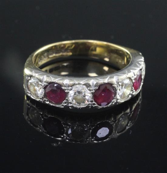 A modern 18ct gold, ruby and diamond seven stone half hoop ring, size Q.